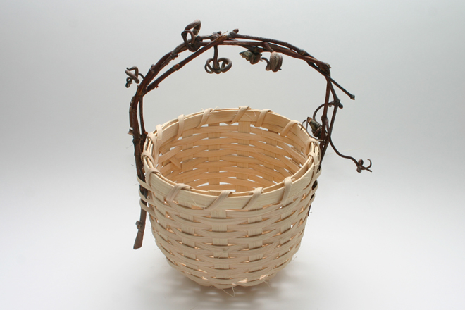 <span style="font-size:14px">SHAKER BASKET</span><br>S. Westfield<br><br>natural cane with a grapevine handle<br><br>approximately 9" tall, 6" diameter
